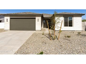 Charming single-story home featuring a two-car garage and low-maintenance desert landscaping in the front yard at 15656 W Mercer Ln, Surprise, AZ 85379