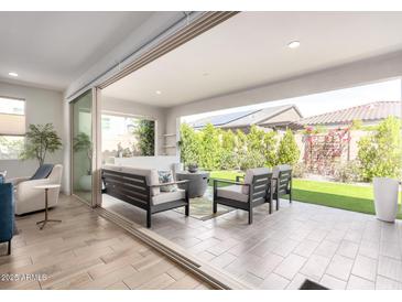 Inviting outdoor living area with comfortable seating and seamless connection to the indoors at 17168 W Mountainair St, Surprise, AZ 85388