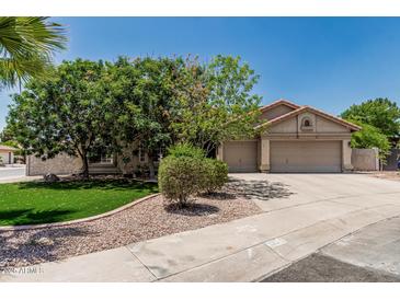 Charming single-story home featuring a well-manicured lawn, mature trees, and a spacious three-car garage at 1754 W San Tan St, Chandler, AZ 85224
