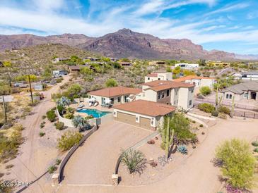 Charming home with a spacious driveway and desert landscaping with a great view of mountains at 3723 S Pottery Rd, Gold Canyon, AZ 85118