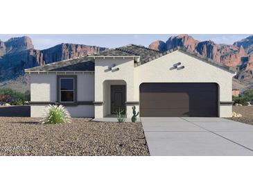 Charming single-story home with a two-car garage and desert landscaping in front at 8519 W Clemente Way, Florence, AZ 85132
