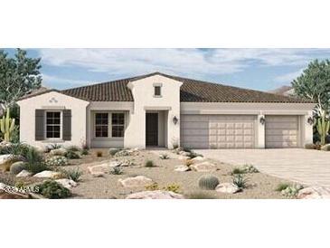 Beautiful single-story home with neutral stucco, three-car garage, desert landscaping and brown roof in Arizona at 980 W Ridge Rd, Apache Junction, AZ 85120