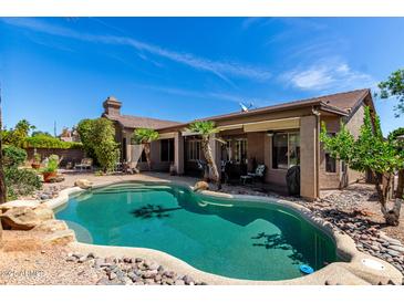 Beautiful backyard features a private pool and well-manicured desert landscaping at 198 N Nevada Way, Gilbert, AZ 85233