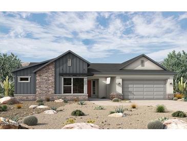 Charming single-story home featuring stone accents, modern architecture, and a two-car garage at 20638 W Berridge Ln, Buckeye, AZ 85396