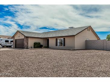 Charming single-story home featuring a stone-accented garage, neutral stucco, and low-maintenance desert landscaping at 3047 W Sandra Ter, Phoenix, AZ 85053