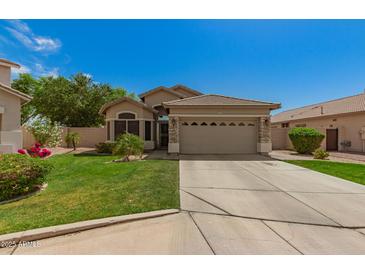 Charming single-Gathering home with a two-car garage and well-manicured lawn at 3239 S Tatum Ln, Gilbert, AZ 85297