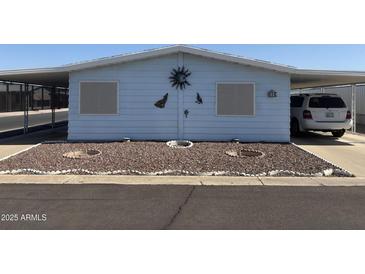 Charming home featuring desert landscaping, carport, and rustic wall decorations at 3330 E Main St # 256, Mesa, AZ 85213