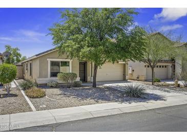 Charming single-story home with a well-manicured, low maintenance front yard and an attached two car garage at 40749 W Thornberry Ln, Maricopa, AZ 85138