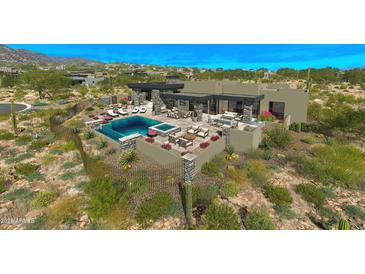 Inviting pool area with ample seating, a fireplace, and desert landscaping create an outdoor oasis at 41639 N 113Th Pl, Scottsdale, AZ 85262