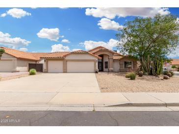 Inviting single-story home featuring a two-car garage and desert landscaping at 19029 N 36Th St, Phoenix, AZ 85050