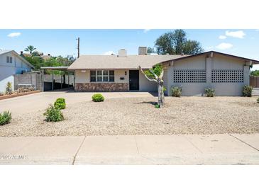 Charming single story home featuring a low maintenance desert landscaped front yard and attached carport at 3237 S Albert Ave, Tempe, AZ 85282