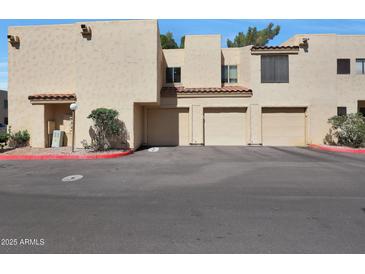 Image of a home's garages and covered parking with desert landscape and rock details at 3441 N 31St St # 118, Phoenix, AZ 85016