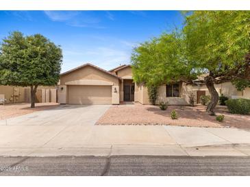 Charming single-story home featuring a well-maintained front yard and a two-car garage at 4222 E Torrey Pines Ln, Chandler, AZ 85249