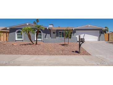 Charming single-story home with low-maintenance desert landscaping and a welcoming two-car garage at 4506 W Golden Ln, Glendale, AZ 85302
