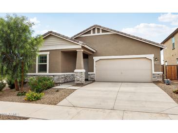Charming single-story home featuring a two-car garage, desert landscaping, and a covered entryway at 11008 N 165Th Ave, Surprise, AZ 85388