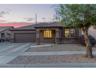 Charming single-story home featuring a well-maintained yard and a two-car garage at 14556 W Shaw Butte Dr, Surprise, AZ 85379