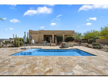 Backyard pool with desert views and stone patio, great for outdoor entertaining and relaxation at 29619 N 142Nd Pl, Scottsdale, AZ 85262