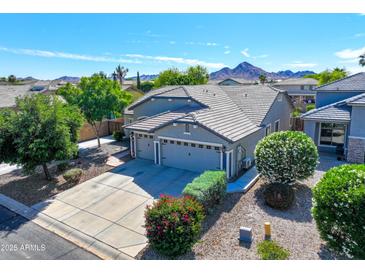Inviting single-Gathering home with a well-maintained yard and a convenient three-car garage at 34942 N Camp Fire Cir, San Tan Valley, AZ 85144