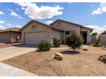 Charming single-story home with desert landscaping, an attached two-car garage, and a neutral color scheme at 4321 E Rowel Rd, Phoenix, AZ 85050