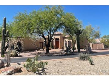 Spacious single-story home featuring desert landscaping and a beautiful terracotta tile roof at 4706 E Rancho Caliente Dr, Cave Creek, AZ 85331