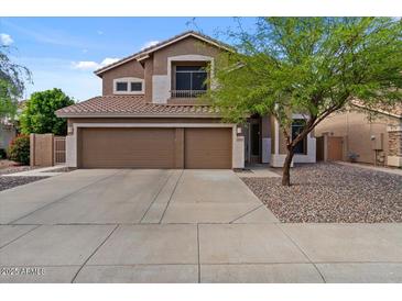 Two-story home featuring a three-car garage and desert landscaping at 5330 W Morgan Pl, Chandler, AZ 85226