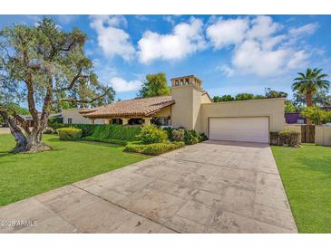 Stunning single-Gathering home featuring desert landscaping and a two-car garage with a beautiful tile roof at 6011 N 2Nd St, Phoenix, AZ 85012