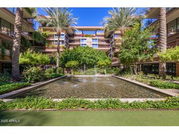 Beautiful courtyard view with water feature, lush landscaping and multi-story building at 7117 E Rancho Vista Dr # 2003, Scottsdale, AZ 85251