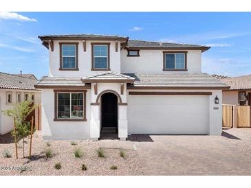 Charming two-story home boasts a neutral exterior with a two-car garage and well-manicured landscaping at 10912 E Tiburon Ave, Mesa, AZ 85212