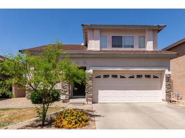 Two-story home featuring a stone facade and a two-car garage, complemented by a well-manicured front yard at 16036 N 11Th Ave # 1086, Phoenix, AZ 85023