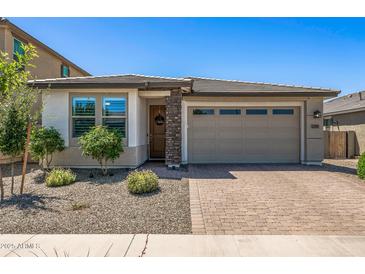 Inviting single-story home featuring desert landscaping and a two-car garage at 22491 E Mewes Rd, Queen Creek, AZ 85142