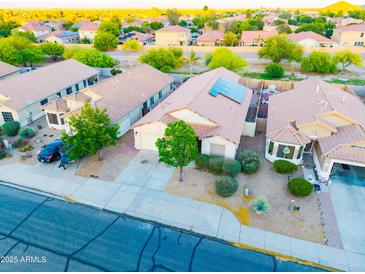 An aerial view shows the beautiful desert landscaping and tile roofs of this suburban neighborhood home at 33105 N Double Bar Rd, San Tan Valley, AZ 85144