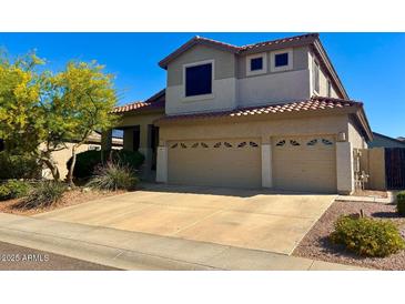 Two-story home with a two car garage, desert landscaping, and a red tiled roof in a suburban neighborhood at 4834 E Robin Ln, Phoenix, AZ 85054