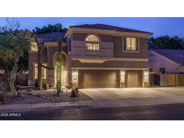 Inviting two-story home with a three car garage and desert landscaping at 6172 W Kerry Ln, Glendale, AZ 85308