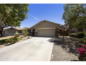Charming single-story home featuring a well-manicured front yard and a spacious two-car garage at 1141 W Stephanie Ln, San Tan Valley, AZ 85143