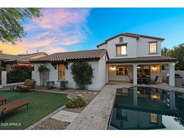 Expansive backyard featuring a pool, patio, and lush landscaping for relaxation and outdoor enjoyment at 13131 N 153Rd Ave, Surprise, AZ 85379
