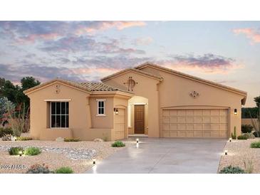 Inviting single-story home featuring a desert landscape, a tile roof, and a two-car garage at 16330 W Jackson St, Goodyear, AZ 85338