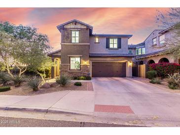 Inviting two-story home featuring a well-manicured lawn and attached two-car garage at 21602 N 36Th St, Phoenix, AZ 85050
