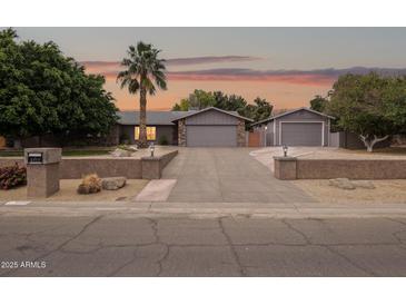 Charming single-story home with a spacious driveway and a well-manicured front yard, showcasing curb appeal at 4112 W Monte Cristo Ave, Phoenix, AZ 85053