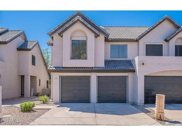 Charming townhome featuring a gray tile roof, a two-car garage, and a well-maintained yard at 480 S Seawynds Blvd, Gilbert, AZ 85233