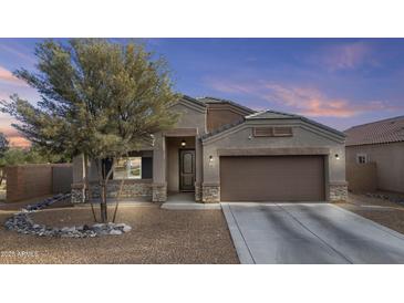 Inviting single-story home featuring a desert landscaped front yard and a convenient two-car garage at 9303 W Oregon Ave, Glendale, AZ 85305