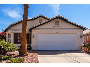 Charming single-story home featuring a two-car garage and well-maintained landscaping at 1279 N Blackstone Dr, Chandler, AZ 85224