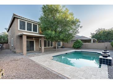 Inviting backyard featuring a refreshing pool, perfect for relaxing and entertaining outdoors at 15028 W Columbine Dr, Surprise, AZ 85379