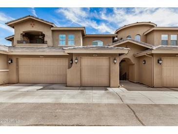Charming townhouse showcasing a two-car garage, neutral stucco exterior, and well-maintained landscaping at 15550 S 5Th Ave # 130, Phoenix, AZ 85045