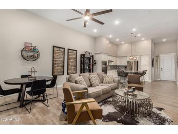Open-concept living space showcases seamless integration of kitchen, dining, and relaxing areas at 15550 S 5Th Ave # 130, Phoenix, AZ 85045