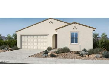 Charming single-story home with neutral stucco, a two-car garage, and a well-manicured desert landscape at 16683 W Hackamore Dr, Surprise, AZ 85387