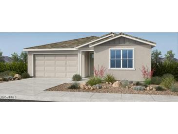 Charming single-story home with a two-car garage and well-manicured front yard, offering curb appeal at 16689 W Hackamore Dr, Surprise, AZ 85387