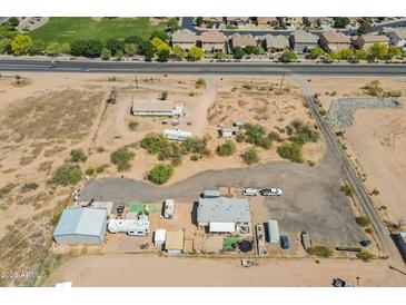 Overhead view of a spacious lot with desert landscaping and a manufactured home, showcasing the property's layout at 22819 E Ray Rd, Mesa, AZ 85212