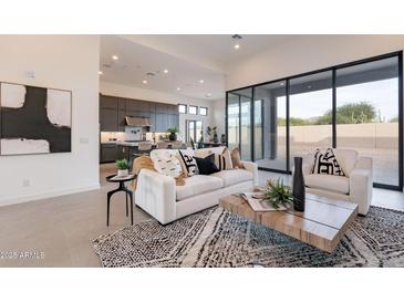 Open-concept living room featuring a stylish white sofa, modern rug, and sleek design elements at 28421 N 59Th Way, Cave Creek, AZ 85331