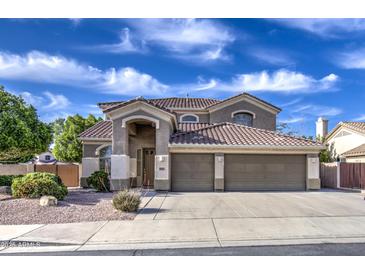 Charming two-story home with a spacious three-car garage and a well-maintained front yard at 6030 W Topeka Dr, Glendale, AZ 85308