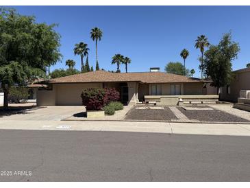 Charming single-story home featuring a well-manicured front yard and desert landscaping at 6712 E Beverly Ln, Scottsdale, AZ 85254